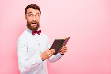 Photo of astonished excited cheerful rejoicing positive glad scientist genius holding opened paper literature in hands isolated pastel background