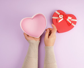 girl opens a red gift  box on a purple background