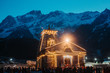 View of the Kedarnath temple lights at night with mountains in the background in Uttarakhand, India