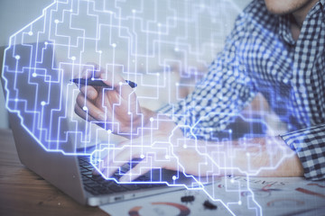 Man typing on keyboard background with brain hologram. Concept of big Data.