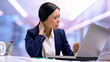 © motortion - Tired business woman suffering from neck pain sitting front laptop, health care