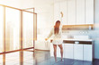 © ImageFlow - Woman in white bathroom corner, sink and tub