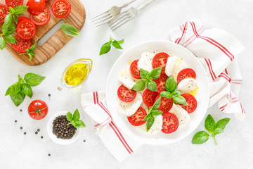 Canvas Print - Fresh italian Caprese salad on white plate, view from above