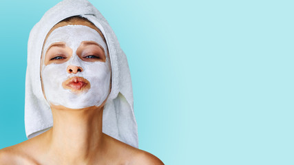 beautiful young woman with facial mask on her face. skin care and treatment, spa, natural beauty and