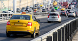Fototapeta Nowy Jork - Yellow taxi car drive on the road in Moscow, Russia
