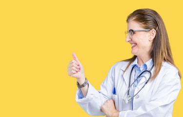 Sticker - Middle age mature doctor woman wearing medical coat over isolated background Looking proud, smiling doing thumbs up gesture to the side