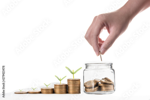 Fotografía Hand putting coin and coins with seed in clear bottle on white background,Busine