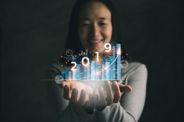 Poster - 2019 New year planning business and financial concept.Businesswoman holding virtual screen of business graph.digital marketing and payment.