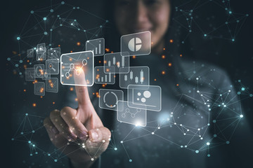 Leinwandbilder - Big data analytics and business intelligence concept with chart and graph icons on a digital screen interface and a businesswoman in background