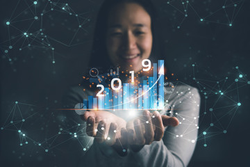 Poster - 2019 New year planning business and financial concept.Businesswoman holding virtual screen of business graph.digital marketing and payment.