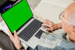 © Creativa Images - Elderly man using laptop with green screen