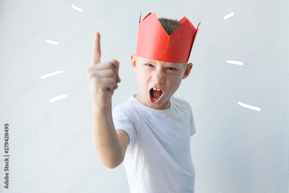 child dictator red paper crown establishes rules - obrazy, fototapety, plakaty 