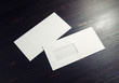 © Veresovich - Blank envelopes with window on dark wooden background. Front and back side. Copy space for text.