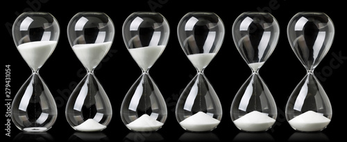 Cuadros en Lienzo Collection of hourglasses with white sand showing the passage of time