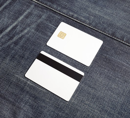 Two blank credit cards on gray denim background. Bank cards. Front and back view.