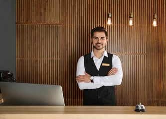 Canvas Print - Portrait of receptionist at desk in lobby