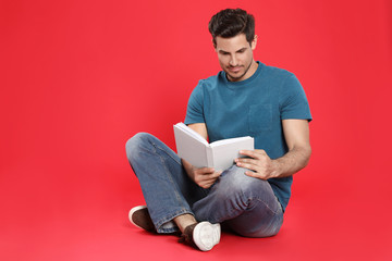 Sticker - Handsome man reading book on color background, space for text