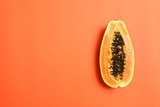 Fresh juicy halved papaya on coral background, top view. Space for text