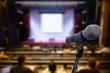 © nattanan - Microphone over the blurred business forum Meeting or Conference Training Learning Coaching Room Concept, Blurred background.