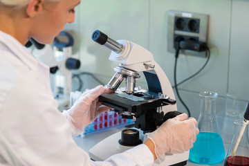 Wall Mural - medical doctor working in research lab. science assistant making experiments. laboratory tools: micr