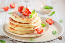 Delicious American Pancakes With Powdered Sugar And Sweet Strawberries