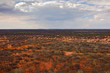 Okonjima Nature Reserve, desert savannah in Namibia landscape. Dry forest with storm grey clouds in Africa. Travelling in Namibia nature.  Trees in Okonjima. Red sand with vegetation.