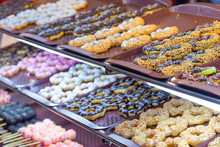Fancy Donuts Or Doughnut On Tray For Sale At Street Food Market.