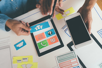 Creative Web Designer planning application and developing template layout, framework for mobile phone. User experience (UX) concept.