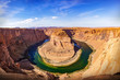 © tanarch - Horseshoe bend panorama view on a sunny day. The most famous landscape at Glen Canyon nation park in Arizona, USA.