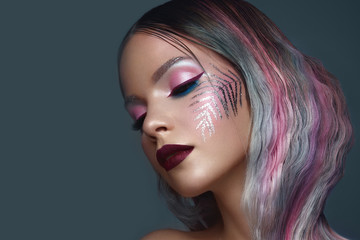 Beautiful girl with multi-colored hair and creative make up and hairstyle. Beauty face.