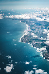 Wall Mural - flight over the coast of portugal lissabon region . aerial view through the airplane window with clo