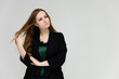 © Вячеслав Чичаев - Concept portrait for the waist of a pretty girl, a young woman with long beautiful brown hair and a black jacket and blue jeans on a white background. In studio in different poses showing emotions.