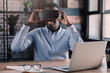 © Damir Khabirov - African businessman in virtual reality goggles sitting in the office