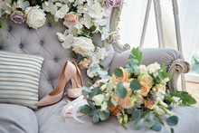 Luxury Beige Bride Shoes On High Heels And Bridal Bouquet In Blur On Lavender Chesterfield Sofa, Copy Space. Wedding Morning Preparations