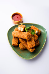 Wall Mural - Kurkuri paneer fingers or pakora/pakoda snacks also known as Crispy Cottage Cheese Bars, served with tomato ketchup as a starter. selective focus