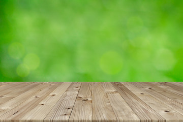 Wall Mural - Brown old plank wooden board as a shelf with blurry bokeh from green natural background. Beautiful texture and pattern of table’s panels build from reused woods pallet.