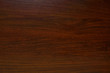 Polished wood texture. The background of polished wood texture with a dark amber color