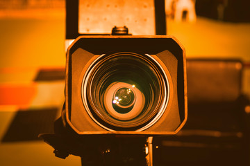 Wall Mural - Video camera on the crane conducts shooting of a wedding in the hall of celebrations against the background of multi-colored fires.Close-up.