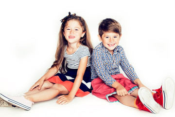 little cute boy and girl hugging playing on white background, happy family smiling close up