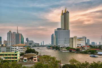 Wall Mural - Bangkok skyline and business skyscrapers at Chaopraya river at sunset