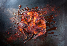 Barbecue Spatchcocked Barbecue Chicken Al Mattone With Hot Chili Sauce As Top View On An Old Metal Sheet