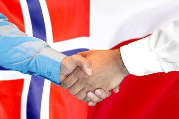 Business handshake on the background of two flags. Men handshake on the background of the Norway and Poland flag. Support concept