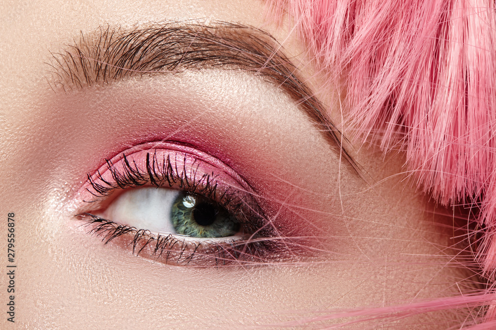 Closeup Macro of Pink Fashion Eye Make-up. Expressive Makeup, Bright Summer Eyeshadows, Magenta Color Hair, Shiny Skin - obrazy, fototapety, plakaty 