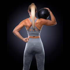 backside view of female athlete fitness trainer athlete, muscular back and buttocks, toned physique