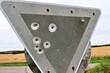 Bullet holes from gun shooting exercises in a german traffic sign
