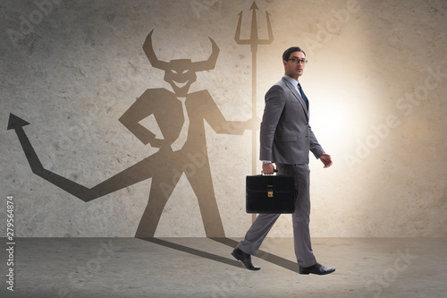 Photographie Devil hiding in the businessman - alter ego concept