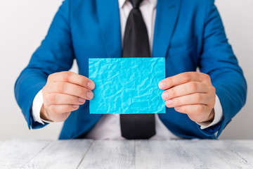 Man holds empty paper with copy space in front of him. White space for advertising message.