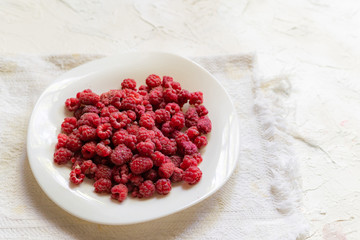 Wall Mural - fresh raw raspberries in the plate, top view