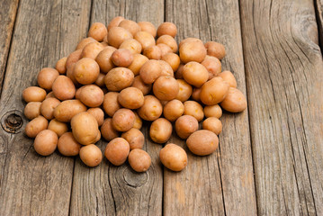 Wall Mural - petite potatoes on rustic wood table background