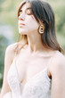 © pavelvozmischev - Bride with long dress in nature with sunset. A stylish wedding in the European style of fine art.